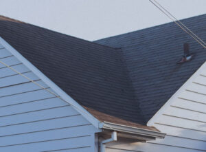 dark roof of a house with white walls